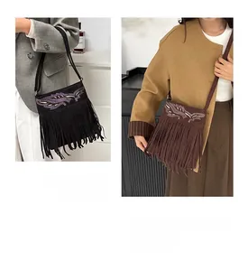 Detail of vintage bohemian crossbody bag with ethnic embroidery and long fringe tassels