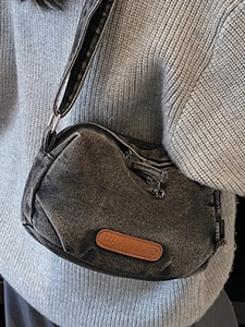 Minimalist washed denim crossbody bag in dark gray with vintage leather patch detail