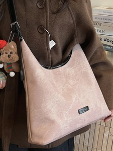 Minimalist light pink textured underarm tote bag with cute brown bear plush charm