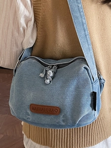 Chic light blue denim crossbody bag with leather patch and adjustable strap for women