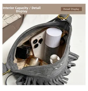 Top view of gray tassel bag interior showing capacity for phone and cosmetics