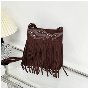 Detail of dark brown suede crossbody bag with bohemian fringe and intricate embroidery