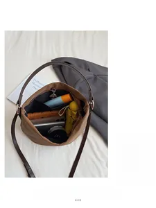 Top view of brown leather bucket bag showing large capacity with daily essentials
