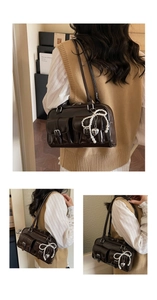 Detail shots of a dark brown vintage shoulder bag with pockets and pearl bow charm