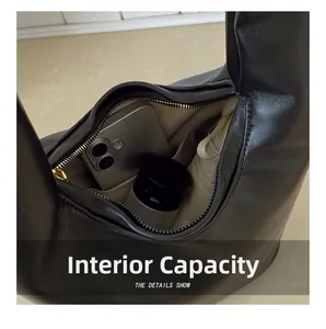 Macro view of black leather bucket bag interior showing large capacity and soft fabric lining