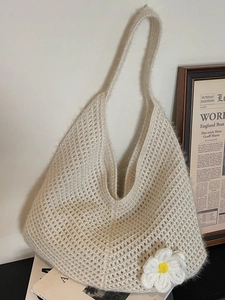 Handmade crochet hobo tote bag in creamy white with a daisy flower floral decoration