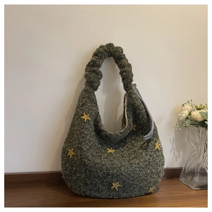 Detail of green fuzzy tote bag with yellow star patch and ruffled scrunchie handle
