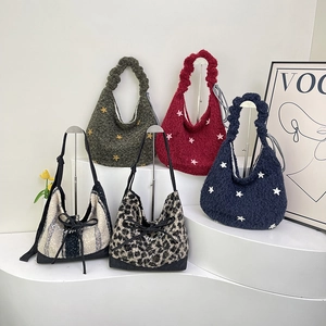 Collection of plush tote bags in leopard print and star patterns on a white display