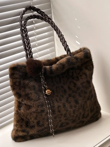 Minimalist large leopard print faux fur tote bag with braided handles and plush charm