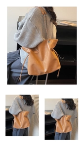 Detail of vintage caramel tote bag featuring drawstring closure and metal chain strap