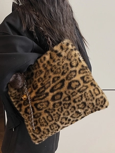 Fashionable leopard print plush tote bag with rope handle and decorative pompom charm