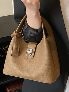 Brown lychee leather bucket handbag with silver buckle and elegant strap detail