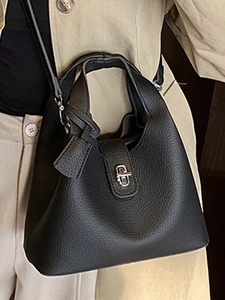 Chic black lychee grain leather bucket bag with silver twist lock and adjustable strap