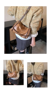 Detailed macro view of vintage caramel brown leather bag with soft texture and golden hardware