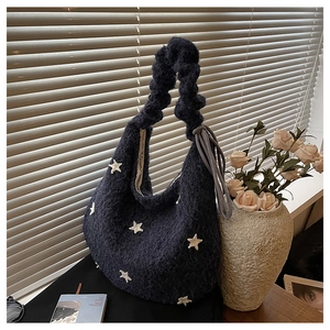Detail view of navy plush hobo bag showing star patterns and ruched handle texture