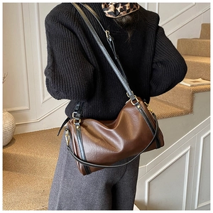 Detailed back view of a large brown vintage Boston bag worn by a model on a shoulder
