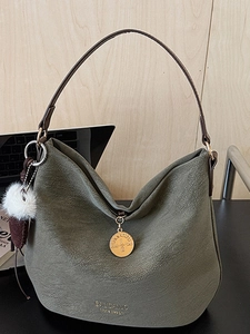 Minimalist olive green vintage shoulder bag with textured finish and pompom detail