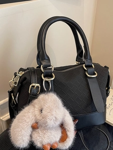 Chic black woven leather pillow handbag for women with a cute pink plush bunny charm