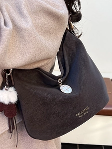 Minimalist vintage brown leather hobo bag for women with gold logo and plush charm