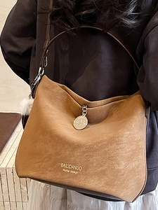 Minimalist tan faux leather hobo tote bag for women with decorative pompom charm