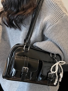 Glossy black shoulder bag with pearl bow charm and front pockets for 2025 fashion