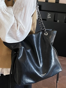 Large black vintage tote bag with chain strap and drawstring detail for women