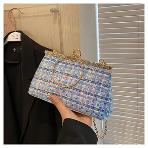 Detail of blue purple sequined tweed evening bag with rhinestone handle and chain