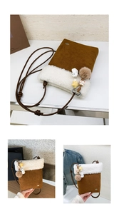 Detail of crossbody bag with brown faux suede and white plush trim including star charms