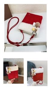 Detail of red plush Christmas crossbody bag with white faux fur trim and colorful charms