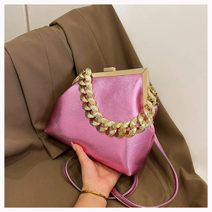 Detail of pink metallic textured bag featuring gold chain handle and frame closure