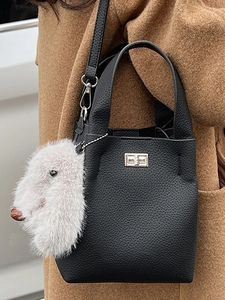 Retro black lychee leather bucket bag with metal lock and white plush bunny charm