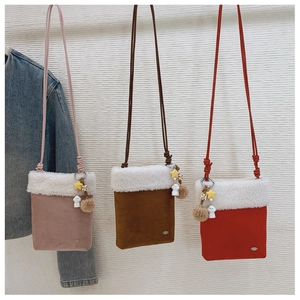Three mini plush crossbody bags in pink, brown, and red with lamb wool trim and star charms