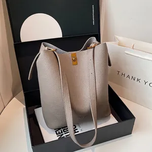 Gray lychee grain leather bucket bag with gold lock in elegant premium gift box packaging