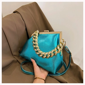 Detail of teal metallic chain bag featuring lychee texture and bold gold hardware