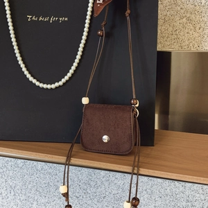 Vintage dark brown mini crossbody bag with suede finish and wooden bead details