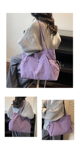 Close-up of large purple tote bag featuring functional drawstring side pockets and wide straps