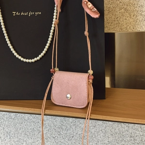Mini pink crossbody bag in brushed suede with silver buckle and decorative beaded strap