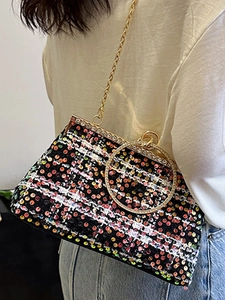 Elegant shell-shaped evening bag with colorful sequins and a diamond-encrusted handle