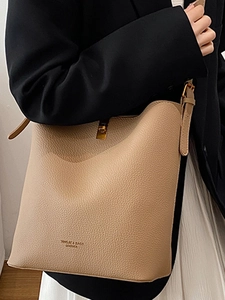 Minimalist apricot leather bucket bag with litchi grain texture and metal buckle