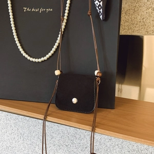 Mini black suede crossbody bag with decorative wooden beads and silver button closure