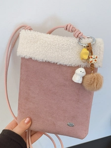 Pink matte suede crossbody bag with white faux fur trim and cute puppy pendant charms