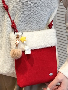 Winter plush crossbody bag in red and white with star and pom-pom charms