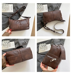 Detail view showing dark brown vintage PU leather texture and stitching on the shoulder bag