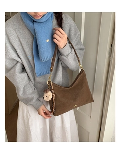 Brown vintage hobo bag in matte leather featuring gold hardware and a cute plush bear charm