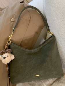 Minimalist deep green suede shoulder bag with a teddy bear charm and gold metal detail