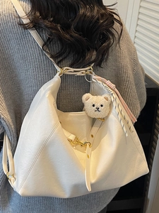 White soft PU leather tote bag with plush bear charm and adjustable strap for women