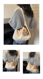 Detail view of beige crescent tote bag with plush bear charm and decorative silk scarf