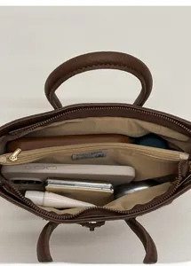 Top view of brown leather handbag showing three compartments and large storage capacity
