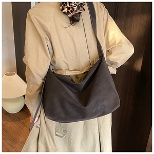 Detail showing the large capacity and soft suede texture of this retro hobo tote bag