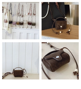 Close-up of minimalist mini crossbody bags featuring retro leather texture and wooden beads